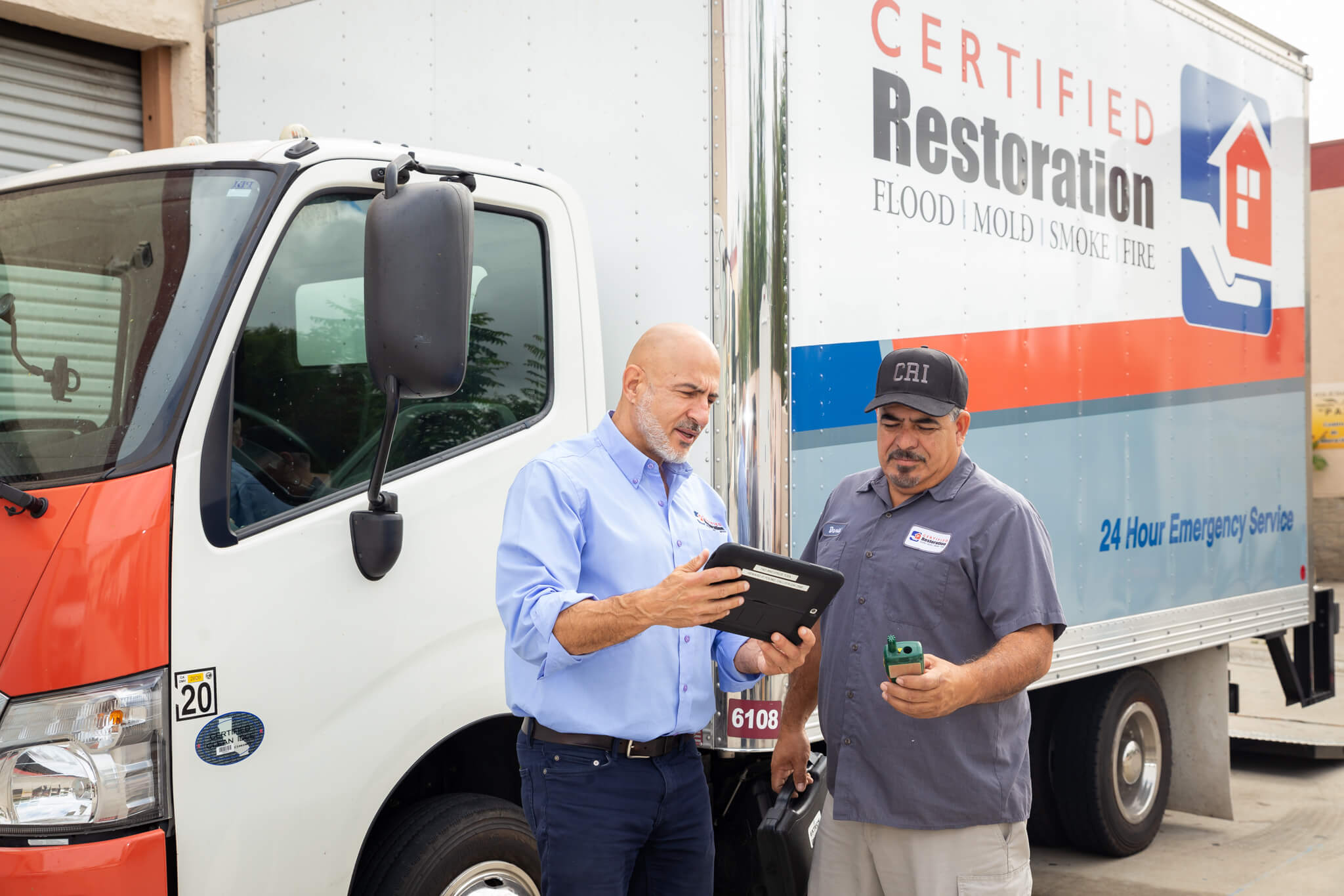 Certified Restoration Inc technicians discussing water damage restoration